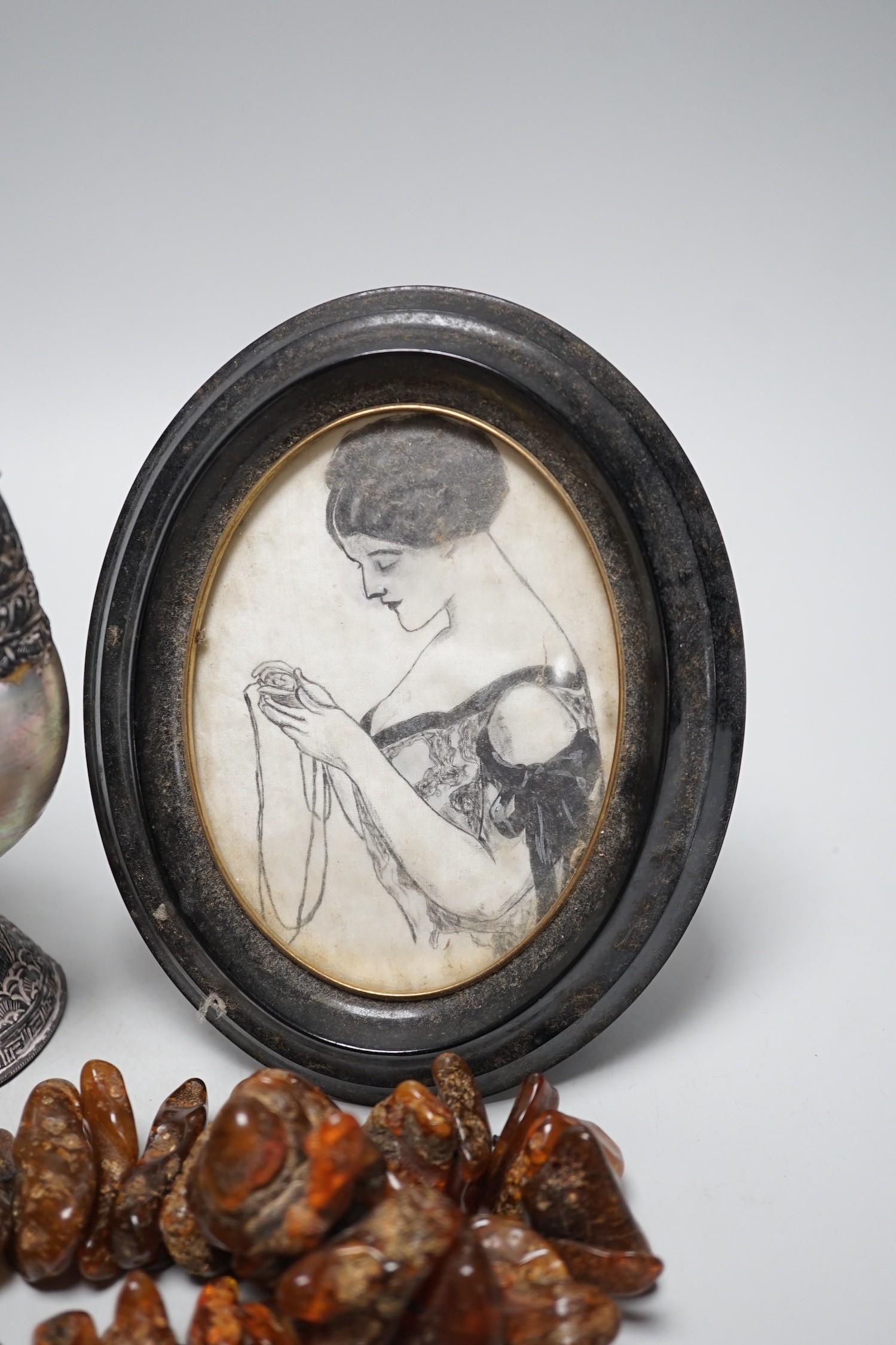A pair of mother of pearl and silvered swan ornaments, amber and mixed collectables